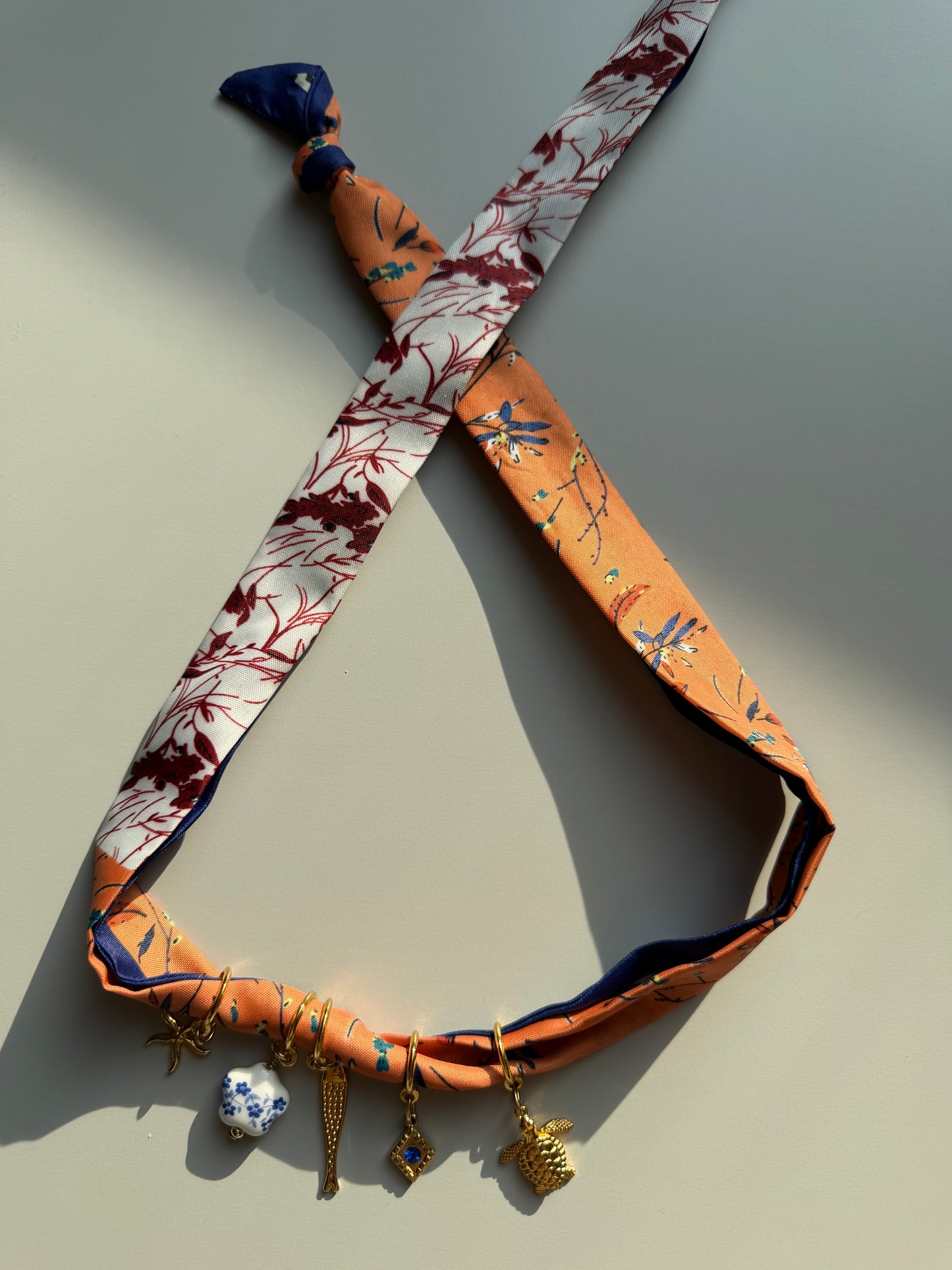 Charm bandana with orange and blue pendants • Gold charms &amp; silk scarf look