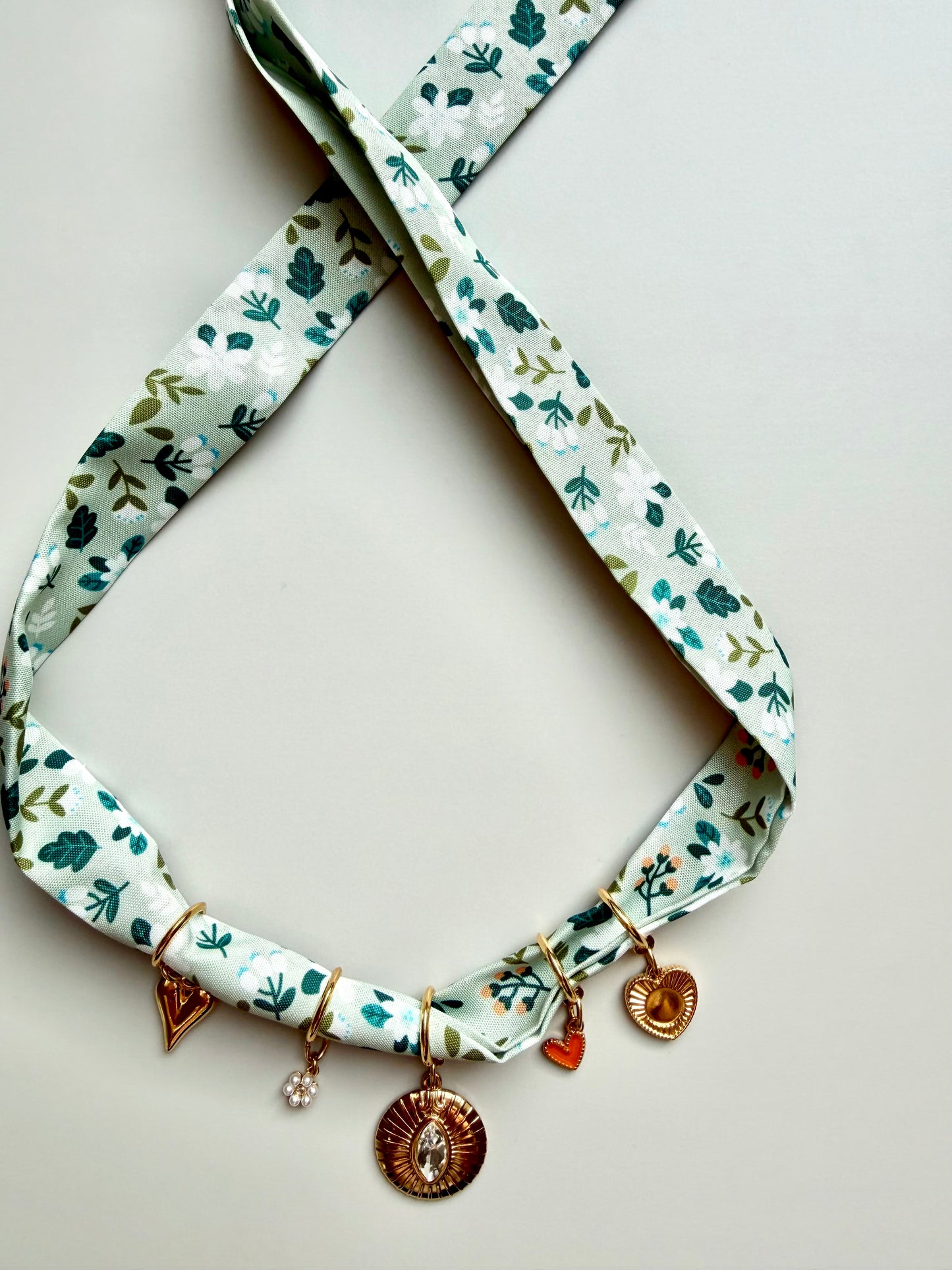 Green charm bandana with floral pattern • Gold heart pendant &amp; crystal