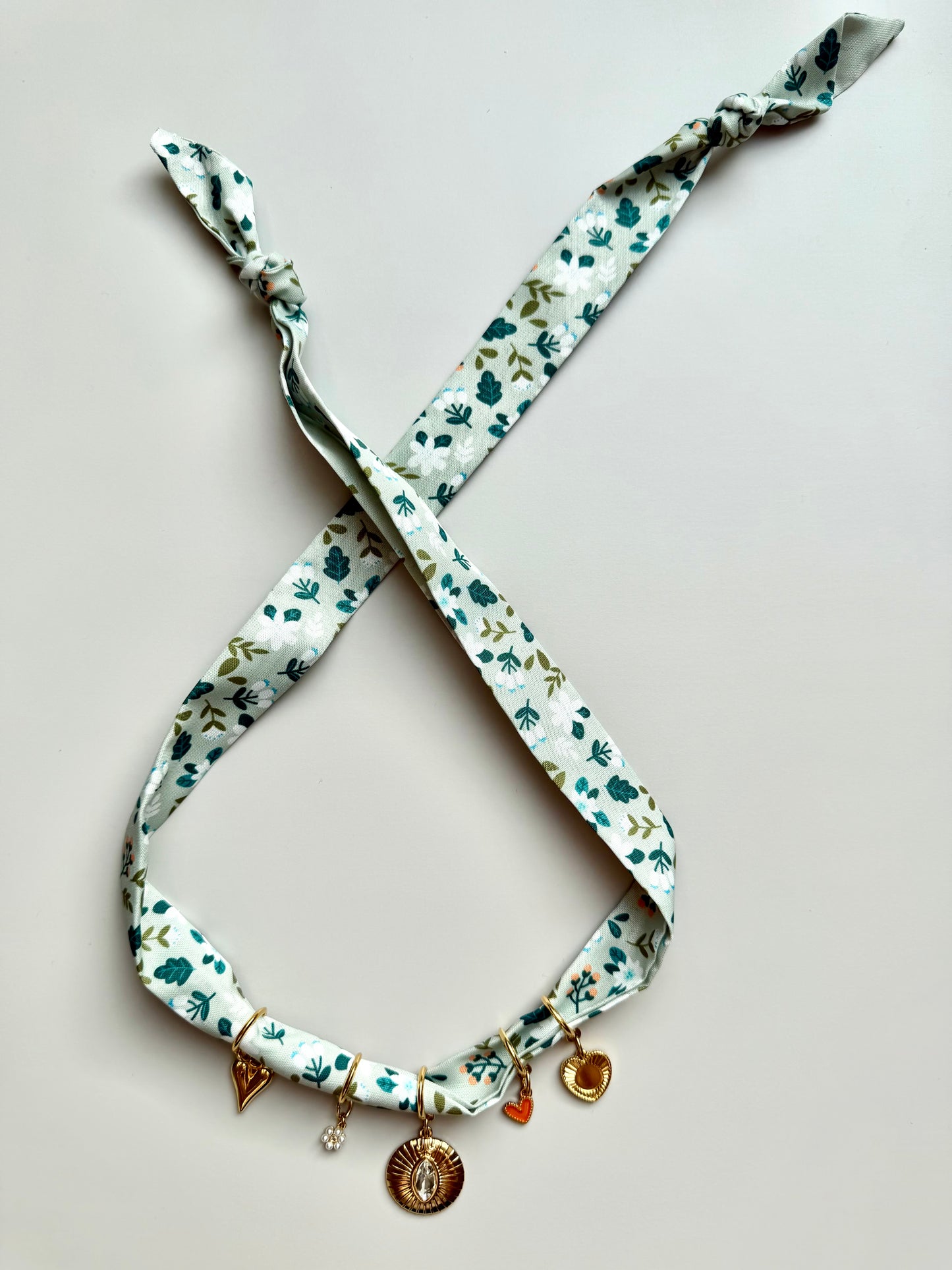 Green charm bandana with floral pattern • Gold heart pendant &amp; crystal