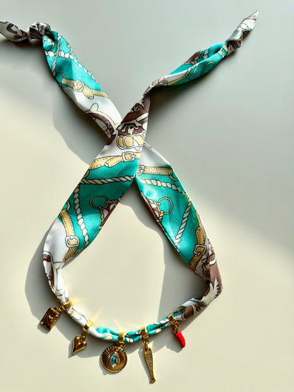 Charm bandana with gold pendants in a turquoise-brown mix • Eye-catching with symbols &amp; crystal detail
